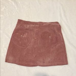 Pink corduroy skirt with heart pockets.